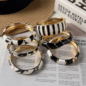 Detailed macro view of stylish vintage black and white enamel gold-plated bangles
