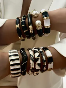 Detailed macro view of vintage black and white enamel bangles with gold-tone accents