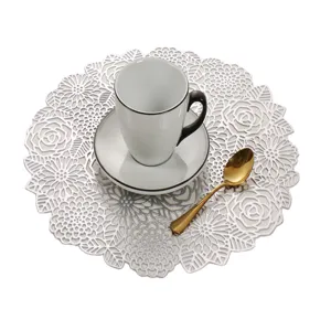 Detail shot of silver hollow floral PVC placemat featuring elegant rose patterns for dining table.