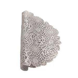 Silver hollow floral PVC placemat detail, washable heat-resistant dining table mat close up.