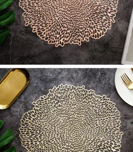 Detailed view of circular metallic hollow placemats, elegant heat insulation dining table decor.