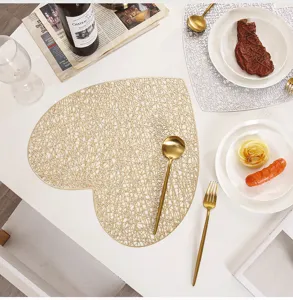 Detail shot of Nordic gold PVC heart hollow placemat in table setting with cutlery.