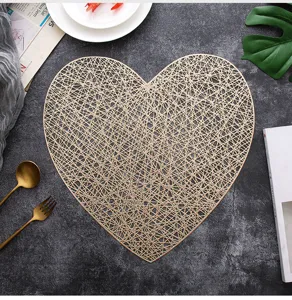 Detail shot of hollow heart placemat, gold PVC table mat set with Nordic lifestyle props.