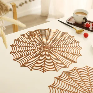 Detailed view of the gold hollow spider web placemat, perfect for Halloween dining table decor.