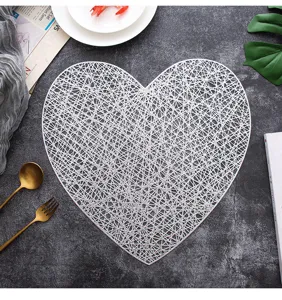 Nordic style hollow PVC heart-shaped placemat, exquisite mesh design for dining decor.