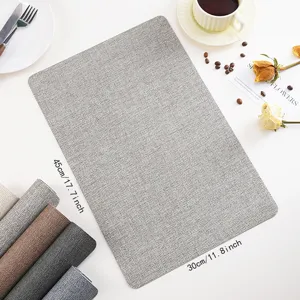 Grey PU leather placemat detailed scene showing waterproof texture and chic tableware setup.