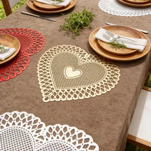 Heart-shaped hollow PVC placemat heat resistant table mat for romantic dining table decor.