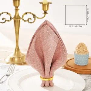 Solid color cotton linen dinner napkin with gold napkin ring for table setting detail view