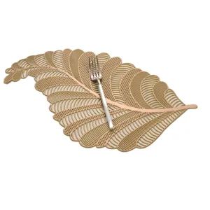 Close-up detail of leaf-shaped hollow PVC gold-stamped placemat for elegant dining decor.