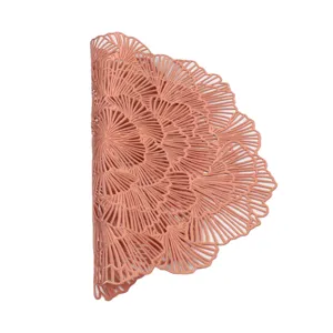 Close-up of rose gold hollow placemat, delicate floral pattern detail, heat-resistant PVC.