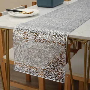 Silver hollow table runner detail view, PVC material with metallic finish for home decor.