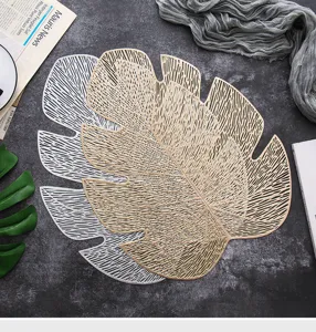Elevate your dining table with these stylish gold and silver PVC hollow leaf placemats.