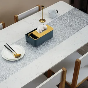 Detailed view of the elegant silver hollow table runner scene setup for home dining decor.