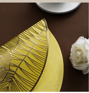 Nordic PVC monstera leaf placemat detail, gold stamping veins, elegant table decor.