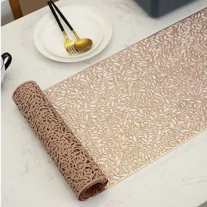 Detail view of the elegant PVC gold-stamped hollow table runner, showcasing delicate floral patterns.
