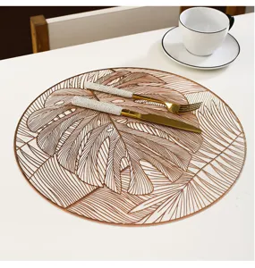 Round monstera leaf PVC table placemat detail, bronzing heat-insulation dining mat.