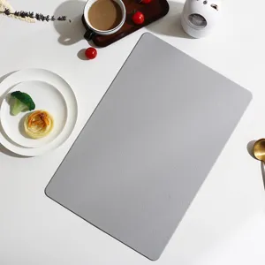 Detail view of a modern grey rectangular leather placemat with fine texture for dining table decor.