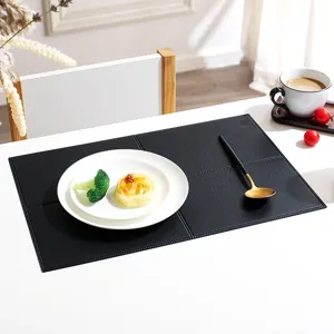 Details of black rectangular PU leather placemat with grid pattern for dining table decor.