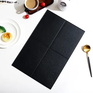 Close-up view of black leather placemat showing neat grid texture and heat insulation details.