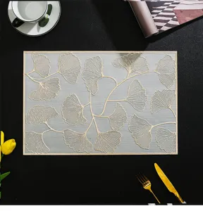 Detailed view of a PVC ginkgo leaf placemat, elegant gold foil design, heat-resistant table mat.