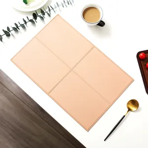 Close-up detail of Nordic faux leather placemat with grid pattern on white table.
