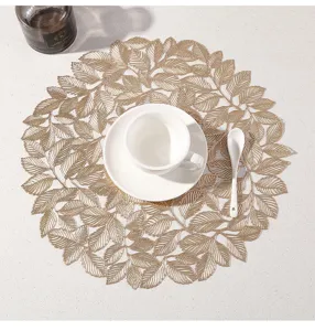 Elegante tovaglietta cava a forma di foglia dorata, tappetino decorativo rotondo per tavolo da pranzo.