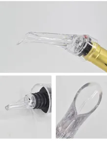 Clear acrylic wine pourer detail view showing the eagle beak spout and rubber stopper design.