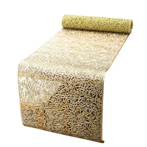 Gold PVC hollow table runner, elegant floral leaf pattern placemat for dining table decor.