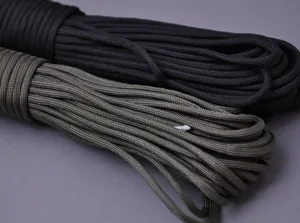 Close-up detail of durable black and olive green multi-strand paracord for outdoor survival.