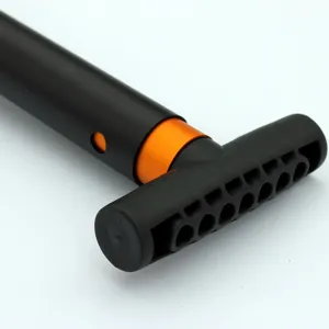 Close-up detail shot of the black and orange outdoor folding shovel handle with ergonomic grip.