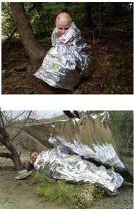 Coperta termica di emergenza di sopravvivenza dettaglio scena uso in natura aperta.