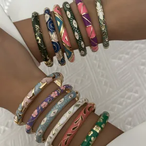 Close-up of ethnic style cloisonné enamel bangles with floral and evil eye patterns