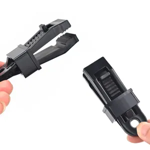 Plastic tent clip detail view showing black heavy-duty awning clamp with adjustable locking design.