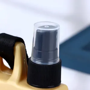 Detail view of portable travel spray bottle nozzle, clear cap and pump for outdoor use.