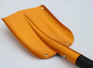 Close-up of orange aluminum alloy snow shovel head, durable outdoor tool detail view.