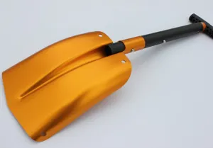 Close-up detail view of the portable orange aluminum alloy camping snow shovel with black handle.