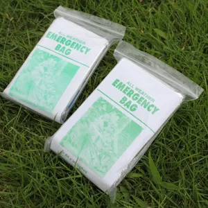 Detail view of emergency survival sleeping bag made of PE aluminum foil, compact outdoor survival gear.