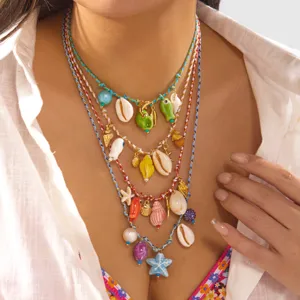 Close-up detail of Bohemian layered necklaces with colorful shell and starfish charms