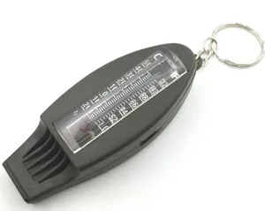 Outdoor survival whistle detail showing built-in thermometer scale and metal key ring.