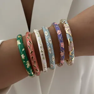 Detailed view of colorful enamel bangles with ethnic patterns and evil eye motifs