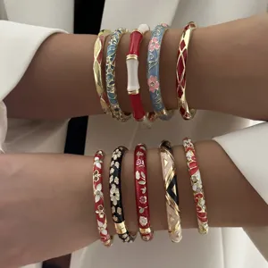 Close-up detail of colorful ethnic floral enamel bangles with intricate patterns