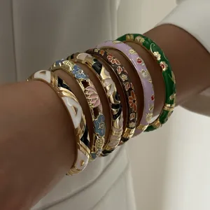 Detailed view of colorful ethnic style enamel bangles with intricate floral patterns