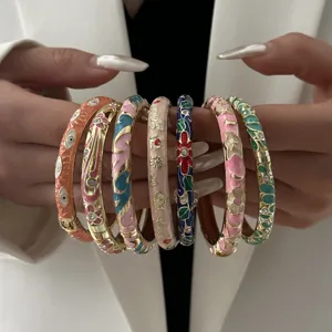 Close-up view of colorful ethnic style cloisonne enamel bangles with floral patterns