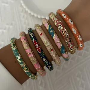 Close-up detail of ethnic colorful enamel bangles with floral patterns