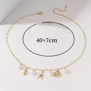 Gold beach style necklace with shell and starfish charms and pearls, 40+7cm length