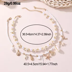 Detailed view of beach style layered necklace with shell and starfish charms