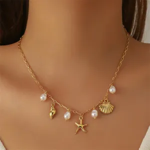 Detailed view of the gold shell and starfish pendant necklace worn on the neck