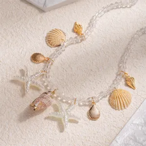 Detailed view of beach vacation style necklace with shell and starfish pendants.