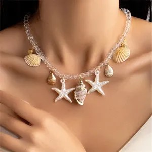 Close-up of beach vacation style necklace with shell and starfish pendants on clear beads