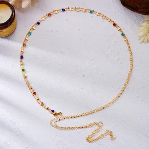 Close-up of golden body chain with colorful round rhinestones for vacation